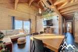 Discover the charm of this stunning property, featuring a spacious living area with exposed wooden beams and a cozy fireplace.