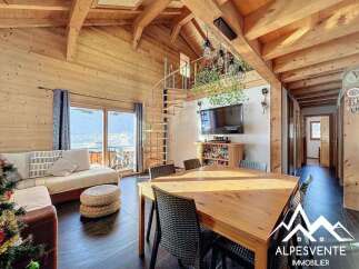 Discover the charm of this stunning property, featuring a spacious living area with exposed wooden beams and a cozy fireplace.