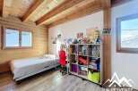 Discover the charm of this cozy bedroom featuring a wooden ceiling and walls, creating a warm and inviting atmosphere.