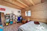 Discover the charm of this cozy bedroom featuring wooden accents and a warm ambiance.