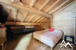 Discover the charm of this cozy bedroom featuring a rustic wooden ceiling and walls, creating a warm and inviting atmosphere.