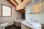 This stunning bathroom features a unique design with exposed wooden beams and a modern sink.