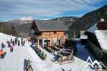 Discover a charming ski chalet nestled in the heart of the mountains, offering stunning views and a cozy atmosphere.