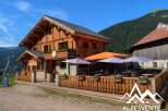 Discover this charming wooden chalet nestled in the mountains, perfect for a cozy retreat.