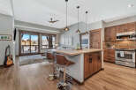 Experience luxury living in this stunning kitchen! Featuring a modern island with seating, stainless steel appliances, and beautiful wooden cabinetry.