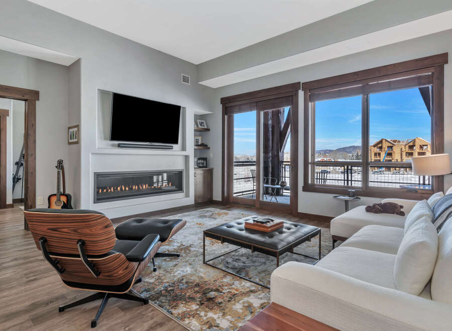 Experience luxury living in this stunning property, featuring a modern fireplace and a sleek, contemporary design.