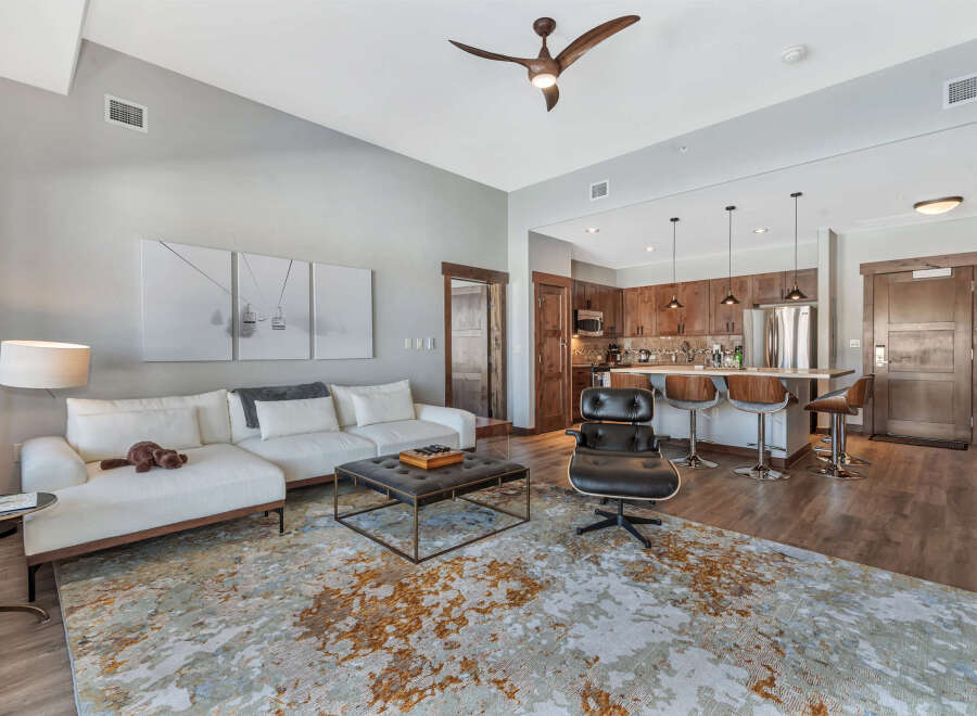 Experience luxury living in this stunning property! This modern space boasts a stylish living area with a comfortable sectional sofa and a chic coffee table.