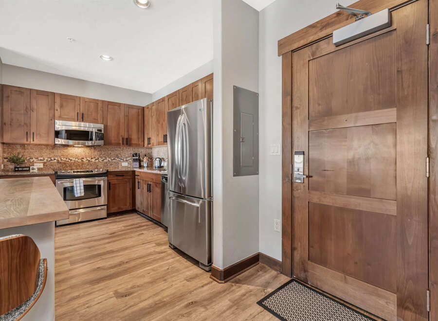 Step into this stunning kitchen with beautiful wooden cabinetry and stainless steel appliances.