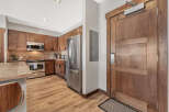 Step into this stunning kitchen with beautiful wooden cabinetry and stainless steel appliances.