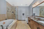 Step into luxury with this stunning bathroom featuring a spacious walk-in shower and a relaxing soaking tub.