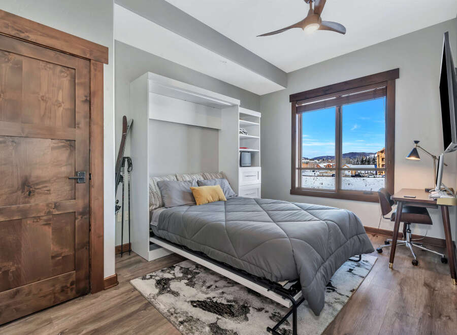 This cozy bedroom features a Murphy bed, maximizing space and offering versatility.