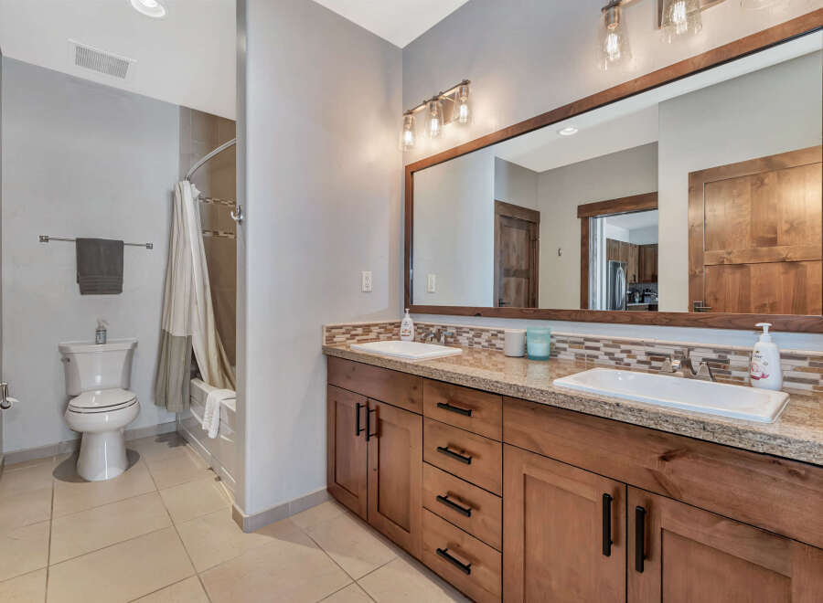 This stunning bathroom boasts a modern design with a touch of rustic charm.
