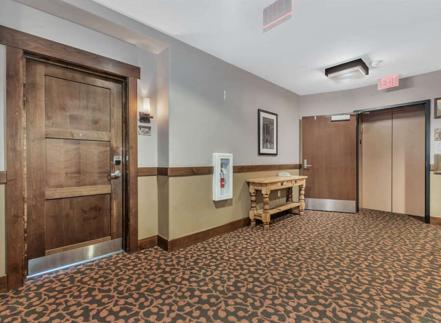 This inviting hallway showcases a blend of rustic charm and modern convenience.
