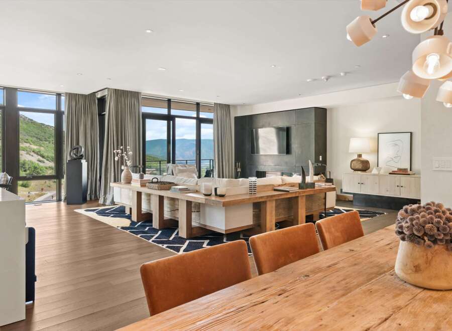 Experience luxury living in this stunning property, featuring expansive windows that frame breathtaking mountain views.