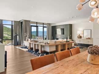 Experience luxury living in this stunning property, featuring expansive windows that frame breathtaking mountain views.