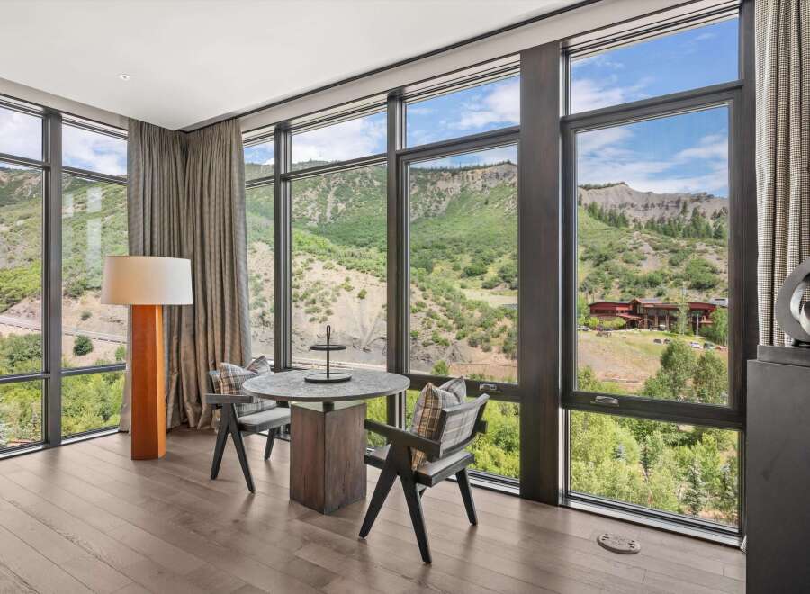 Experience breathtaking views from this luxurious property, featuring expansive windows that frame the stunning natural landscape.