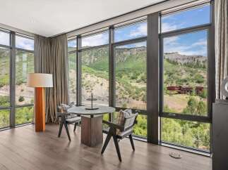 Experience breathtaking views from this luxurious property, featuring expansive windows that frame the stunning natural landscape.