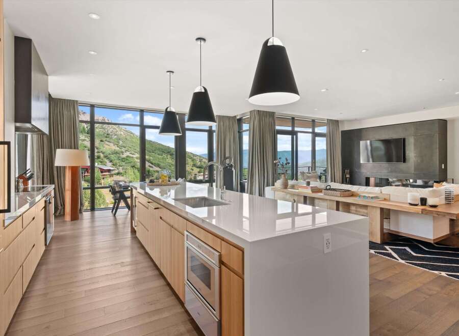 Experience luxury living in this stunning property, featuring a modern kitchen with sleek countertops and high-end appliances.