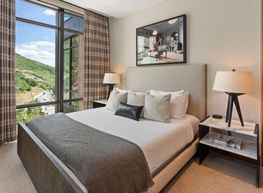 Experience luxury living in this stunning bedroom, featuring a spacious layout and elegant design.