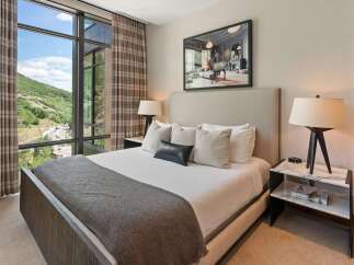 Experience luxury living in this stunning bedroom, featuring a spacious layout and elegant design.