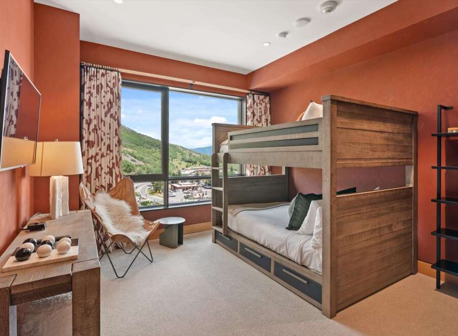 This stunning bedroom features a custom-built bunk bed, perfect for accommodating guests or family.