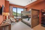 This stunning bedroom features a custom-built bunk bed, perfect for accommodating guests or family.