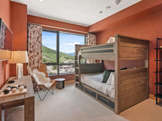 This stunning bedroom features a custom-built bunk bed, perfect for accommodating guests or family.