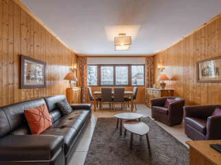 This cozy living space features warm wood paneling, creating a welcoming atmosphere.