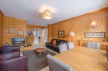 Step into this inviting living space, featuring warm wooden paneling and a cozy atmosphere.