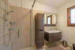 This modern bathroom features a sleek shower enclosure and stylish vanity.