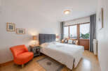 This cozy bedroom features a comfortable bed with a stylish headboard, perfect for a relaxing retreat.
