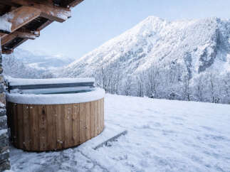 Experience the ultimate winter escape with this stunning property featuring a luxurious hot tub.
