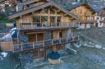 Experience luxury mountain living in this stunning chalet, featuring a private hot tub perfect for relaxing after a day on the slopes.