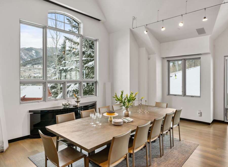 Experience luxury living in this stunning property, featuring a spacious dining area with breathtaking mountain views.