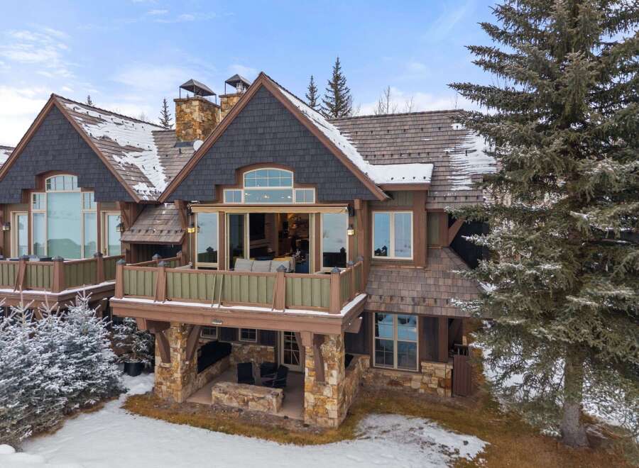 This stunning mountain home boasts a beautiful exterior with a combination of stone and wood accents.