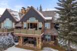 This stunning mountain home boasts a beautiful exterior with a combination of stone and wood accents.