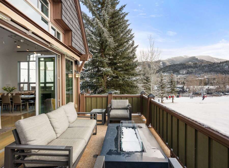 Experience luxury living with this stunning property featuring a spacious outdoor deck perfect for enjoying the winter wonderland.