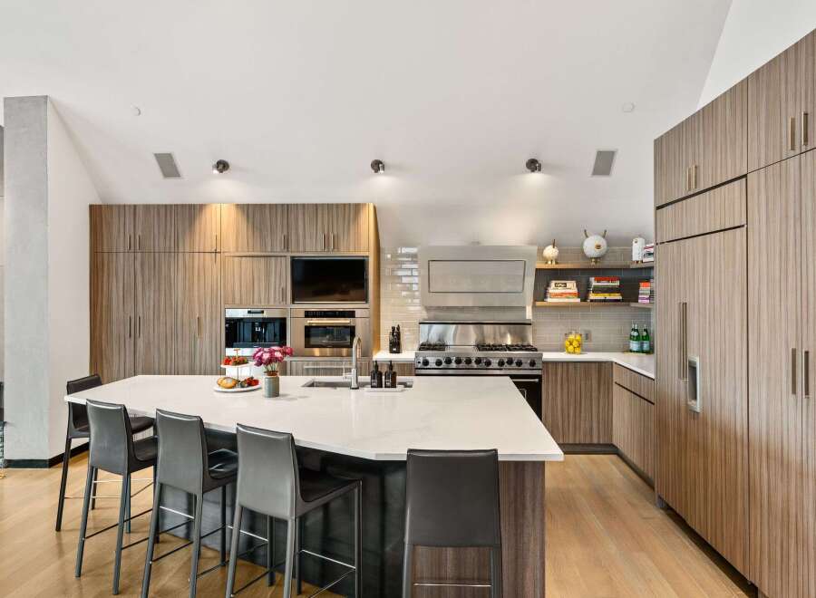 Experience luxury living in this stunning kitchen! Featuring a modern design with sleek cabinetry, a spacious island, and top-of-the-line appliances, this kitchen is perfect for both cooking and entertaining.