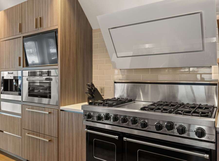 This modern kitchen boasts high-end appliances and sleek design.