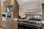 This modern kitchen boasts high-end appliances and sleek design.