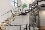 Step into luxury with this stunning property featuring a modern staircase design and an elegant chandelier.