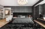 Experience luxury in this stunning bedroom featuring a plush, oversized rug and a statement chandelier.