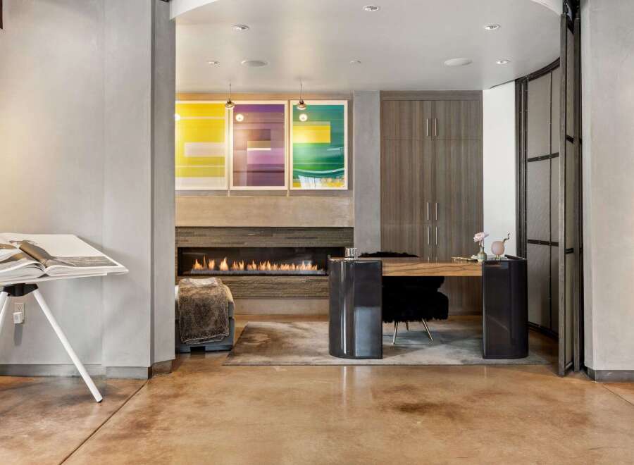 This stunning property boasts a modern interior design with a cozy fireplace, perfect for relaxing evenings.