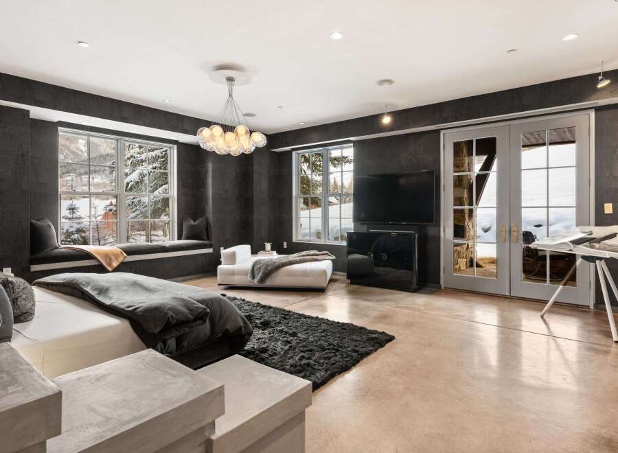 Experience luxury living in this stunning bedroom featuring a modern design and breathtaking views.