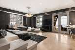 Experience luxury living in this stunning bedroom featuring a modern design and breathtaking views.