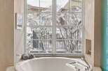 Indulge in luxury with this stunning bathroom featuring a round soaking tub, perfect for unwinding after a long day.