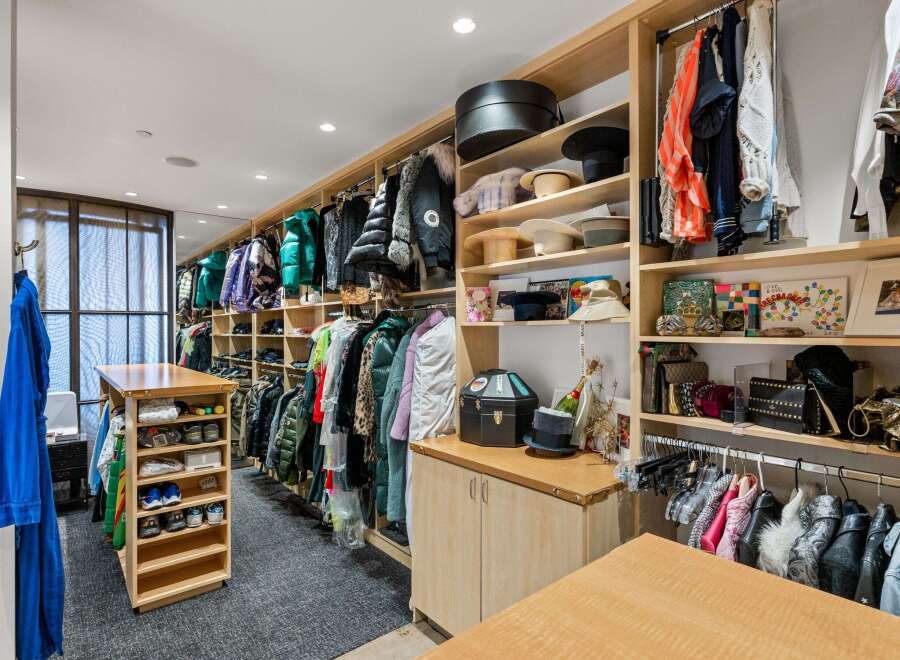 Step into luxury with this meticulously designed walk-in closet, a true haven for fashion enthusiasts.