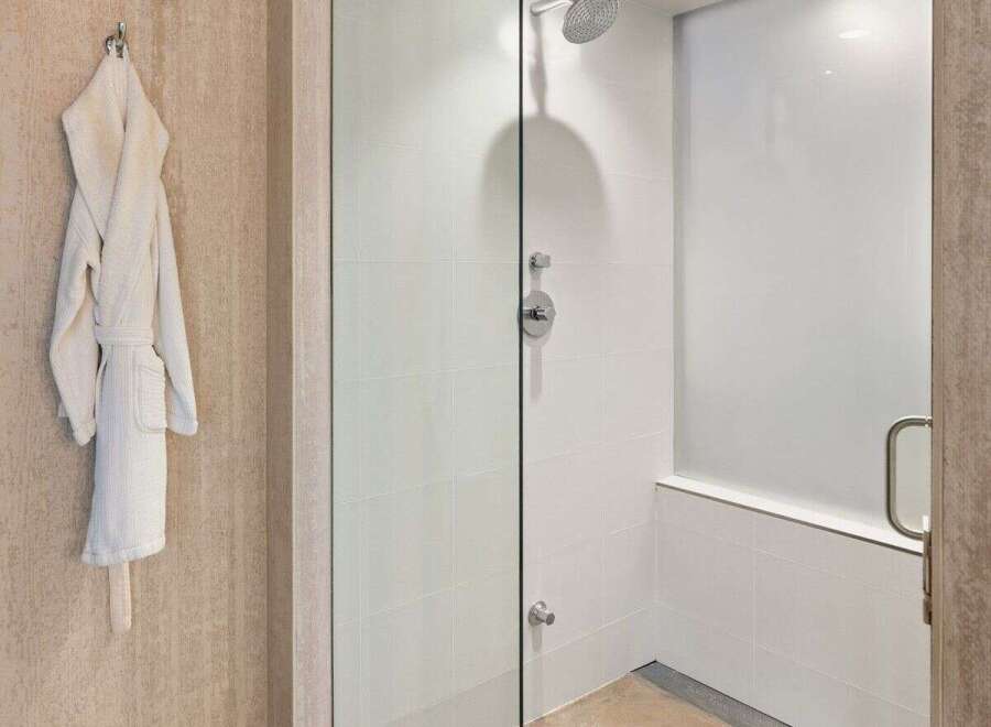 Step into luxury with this stunning bathroom featuring a modern glass shower.