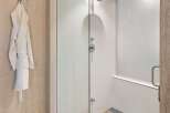 Step into luxury with this stunning bathroom featuring a modern glass shower.
