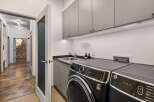 Step into modern convenience with this stylish laundry room.